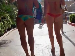 2 beauties walk around the town in exposing swimsuits